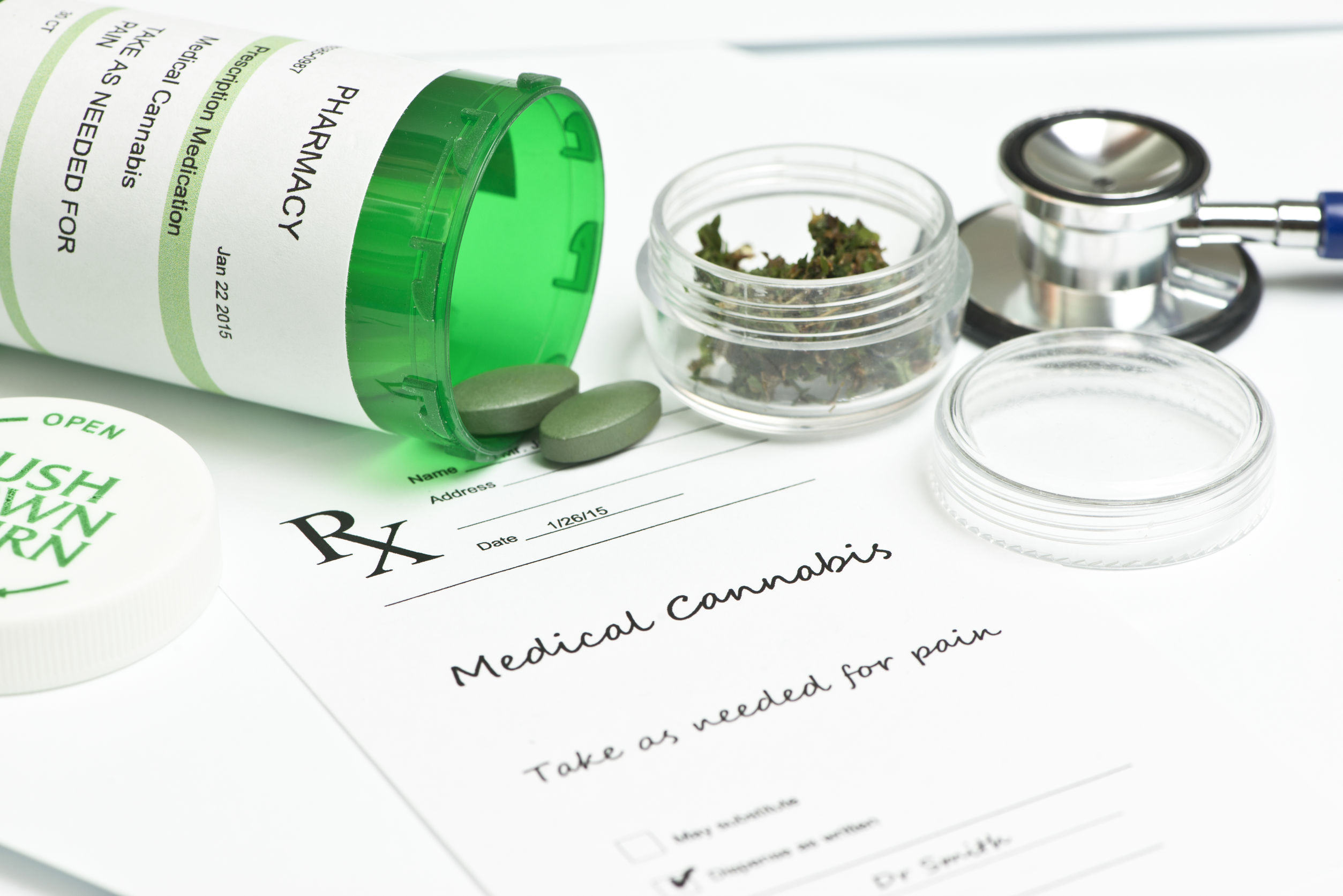 medical marijuana prescription with bottle and stethoscope.