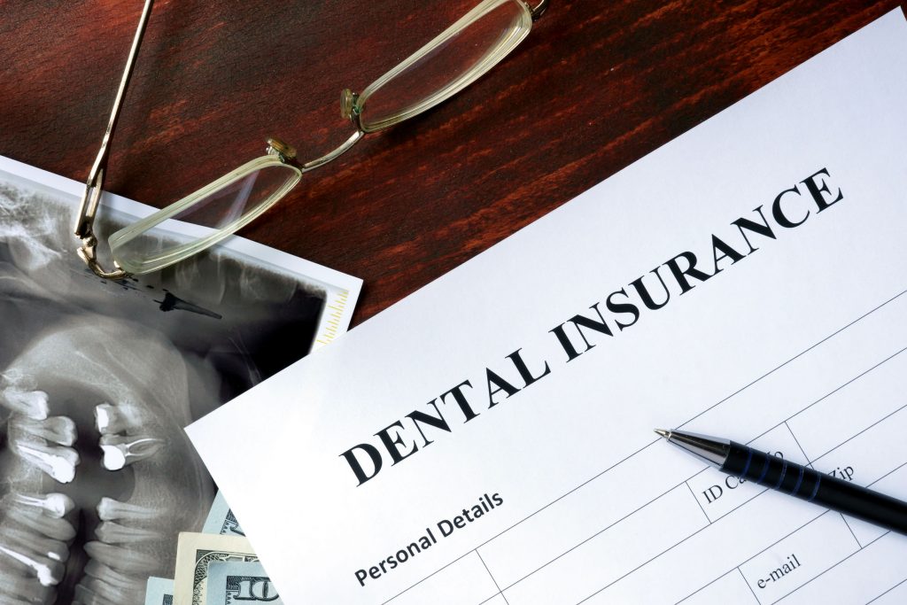 alternate benefit clause - dental insurance form on the wooden table.