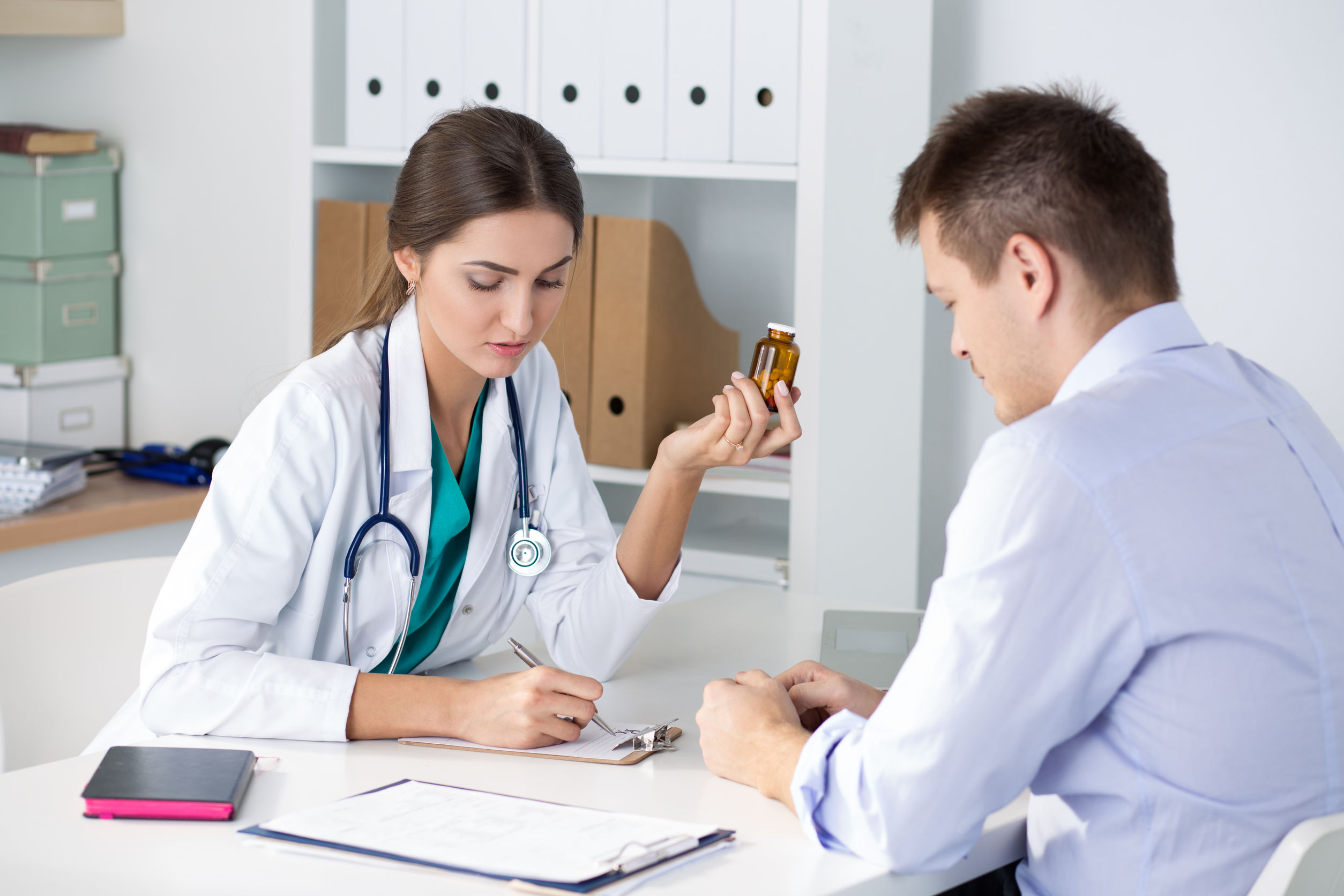 female medicine doctor prescribing pills to her male patient. healthcare, medical and pharmacy concept.