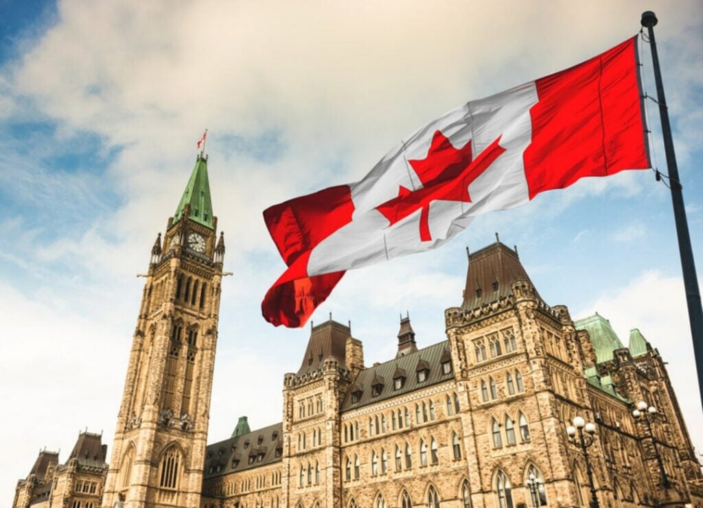 Canadian flag flying in front of Parliament in Ottawa