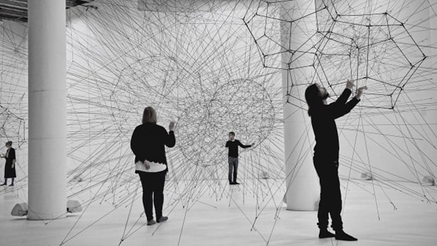 People interacting with an art exhibit