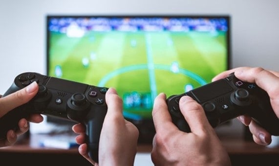 Two people playing a sports video game