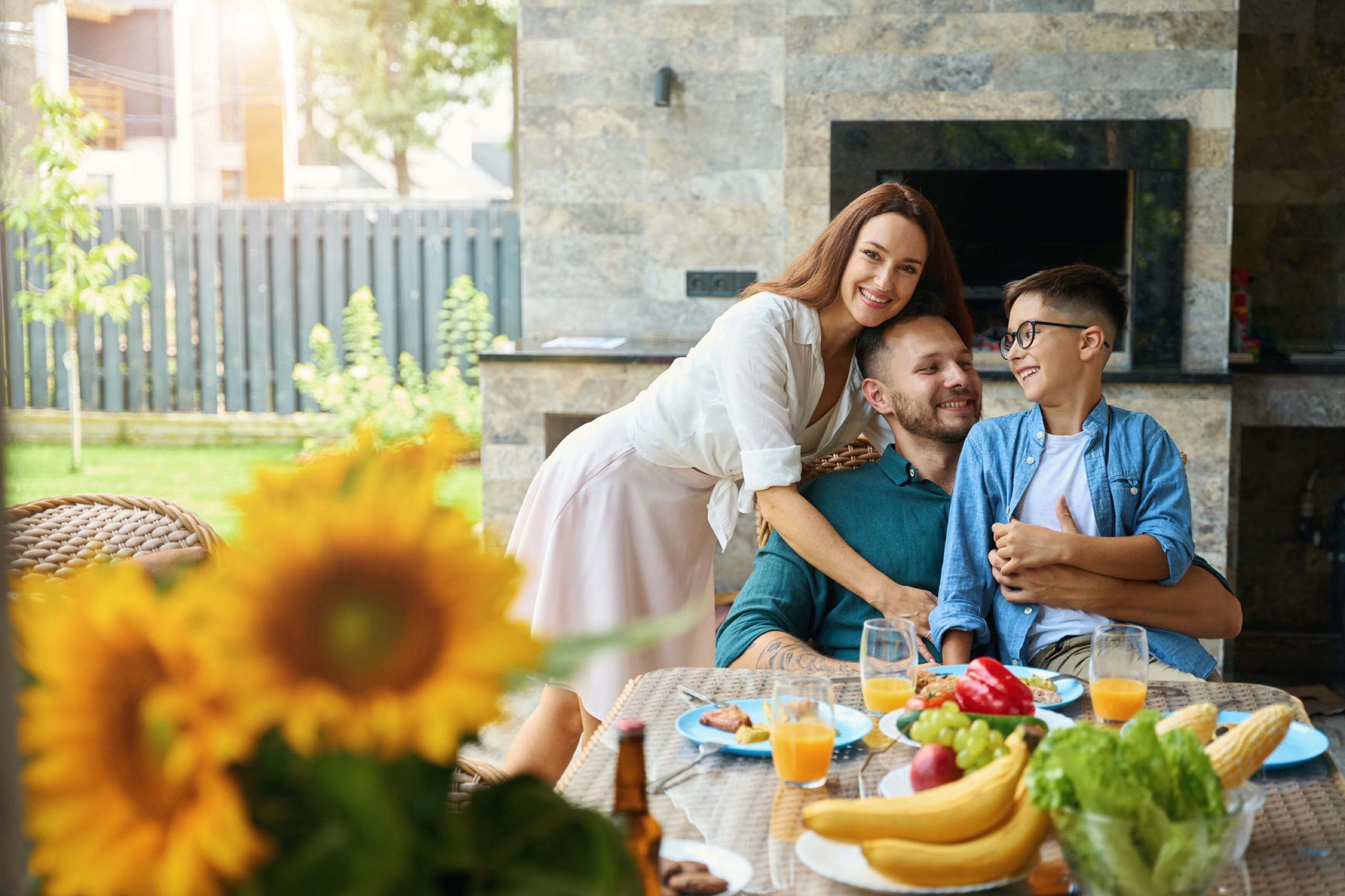 Friendly family has a nice conversation at the dinner table, they smile and hug