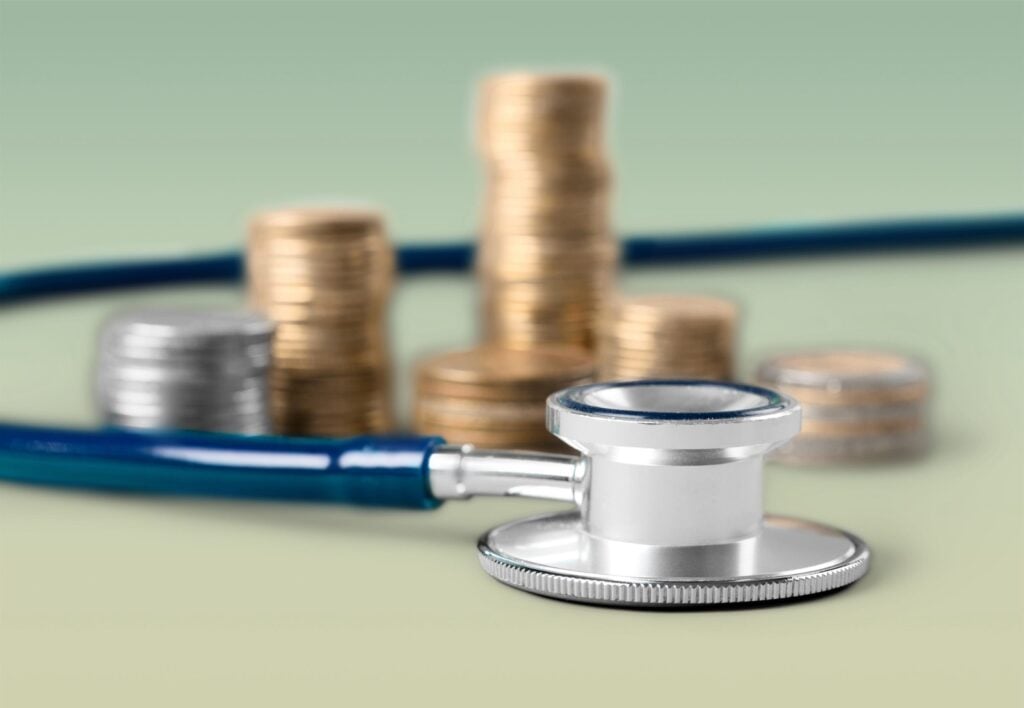 Stethoscope on currency coins, close-up view