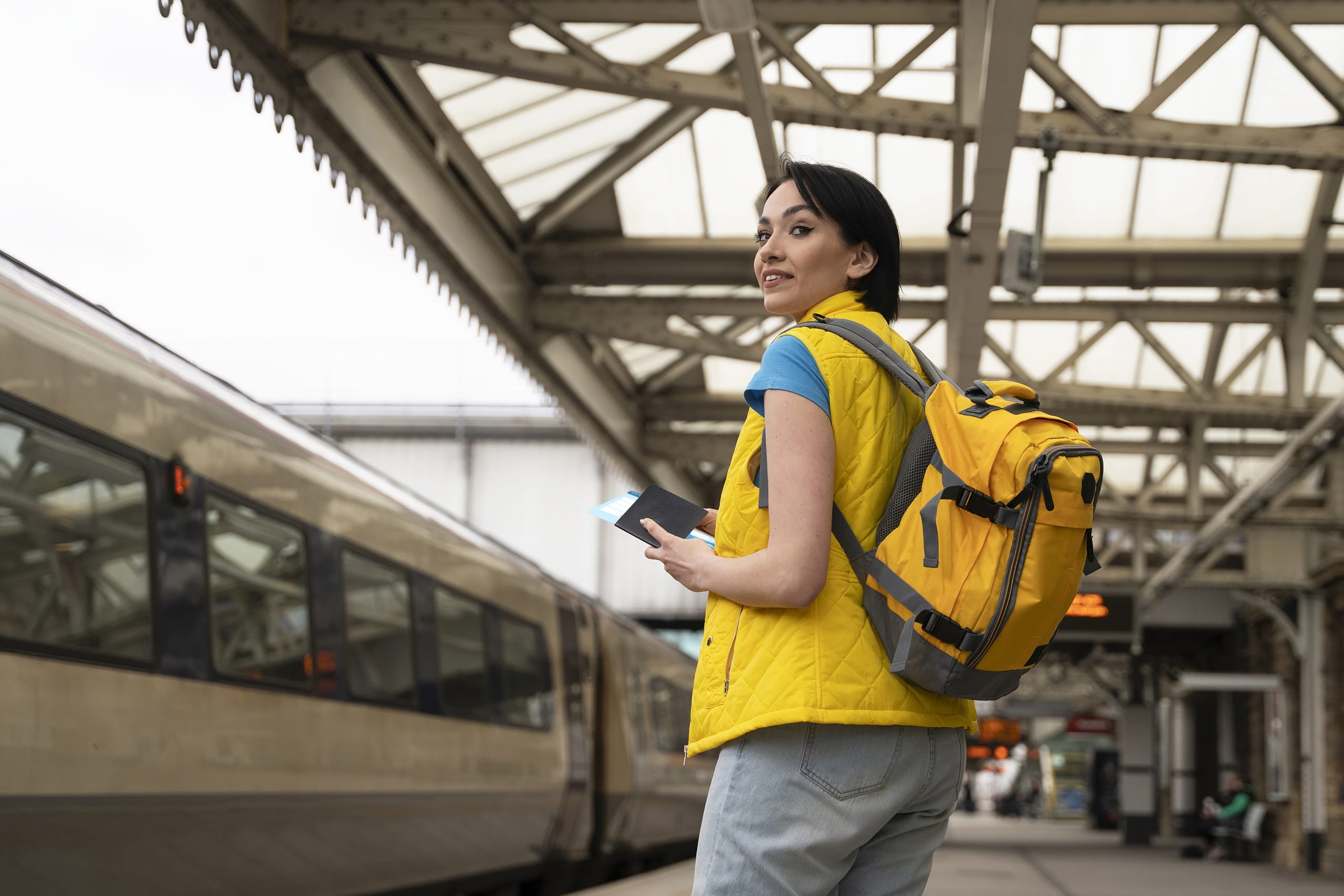 Woman in yellow traveling in Europe by train
