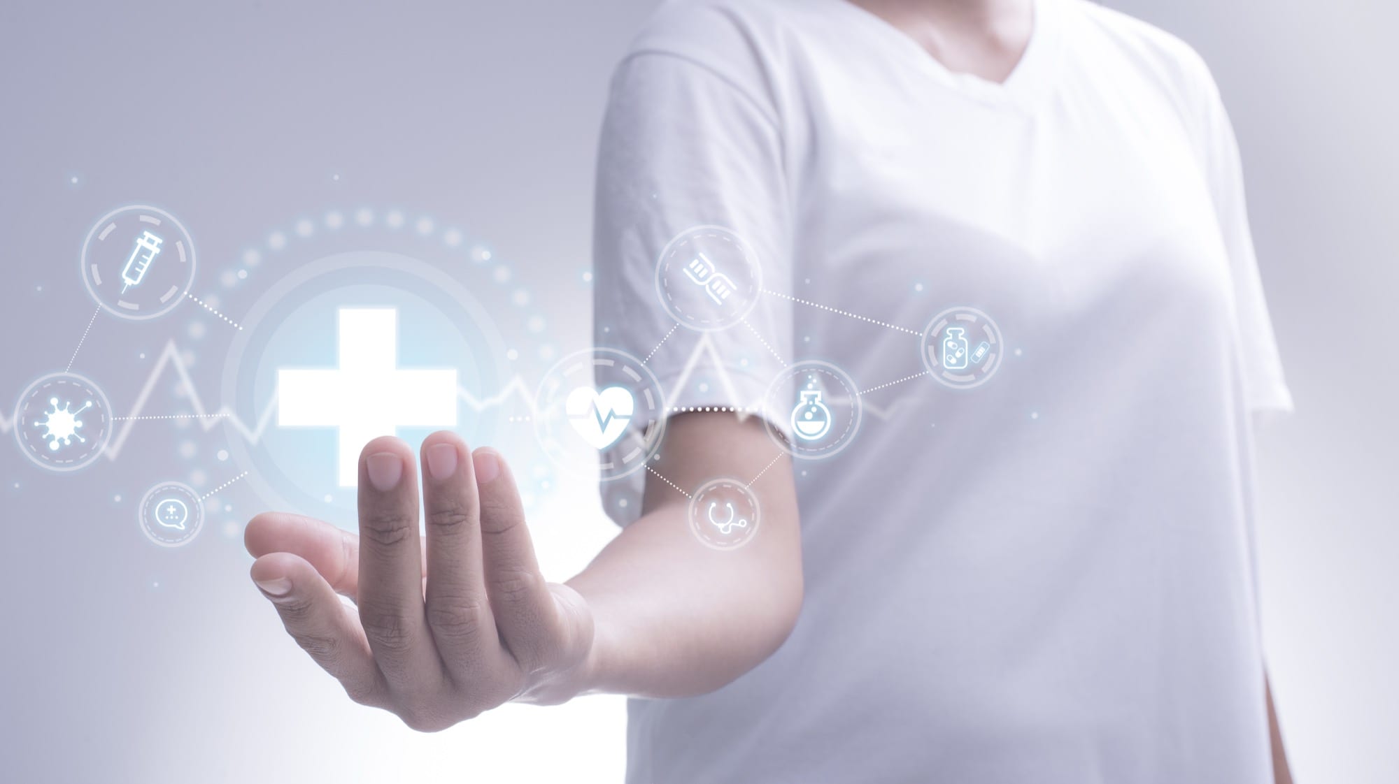 Glowing health symbol hovering over an outstretched hand