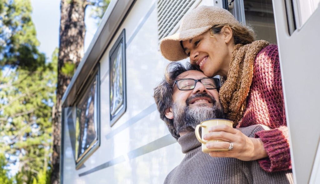 Happy couple outside an RV